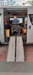 toyota hiace hiroof maxi cab wheelchair transport ramp deployed wheelchair user in the maxi cab