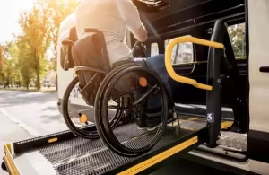 wheelchair user boarding wav on wheelchair hydraulic lift