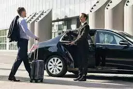 singapore maxi cab airport transfer changi airport picture showing a passenger walking towards a mercedes e class and driver is holding open the door